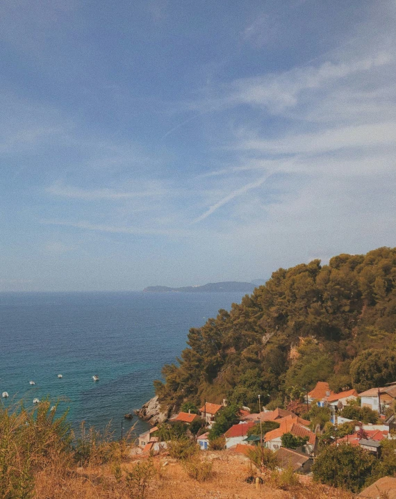 a person looking out over a bay with a boat docked