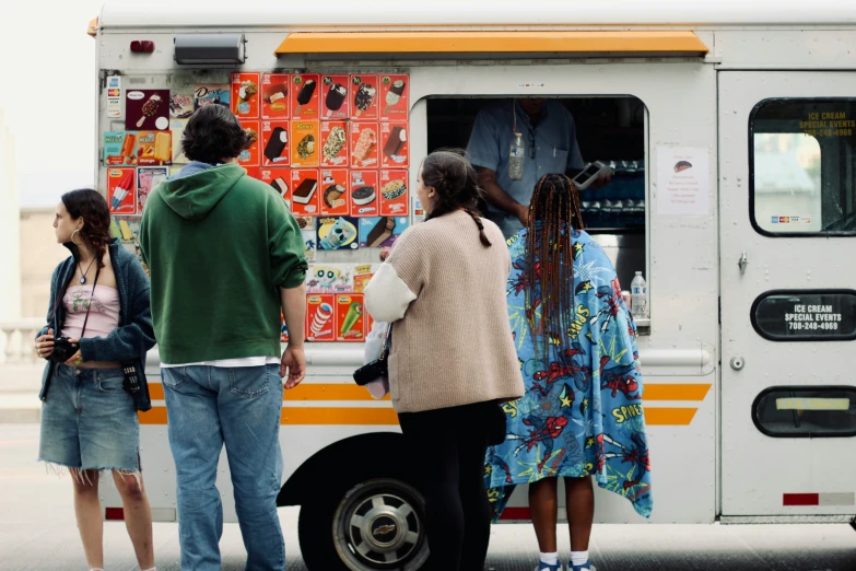 group of people waiting to get their order from an ice cream truck