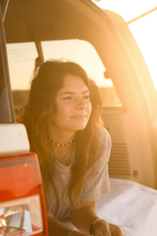 woman sitting in the back of a pick up truck