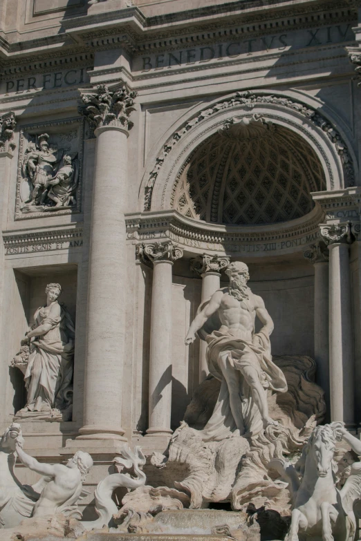 sculptures near the entrance to a large building