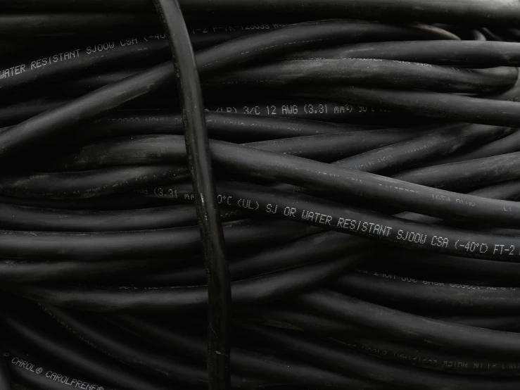 some black wires are stacked in a spiral