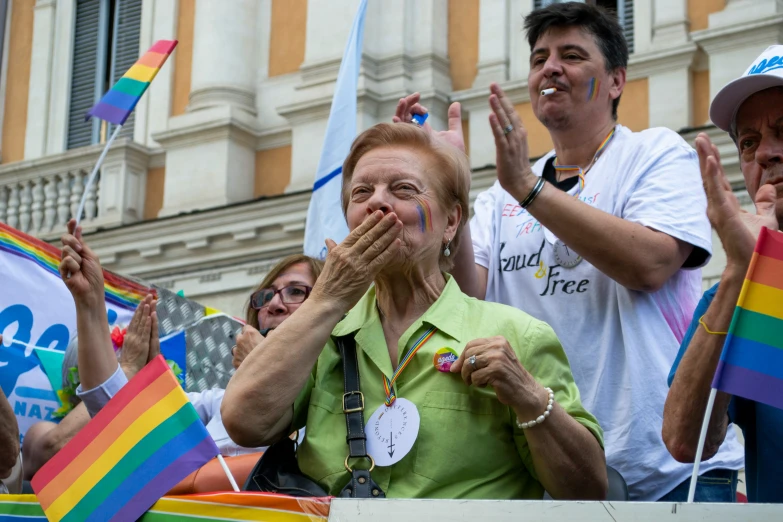 people in the street watching and holding flags