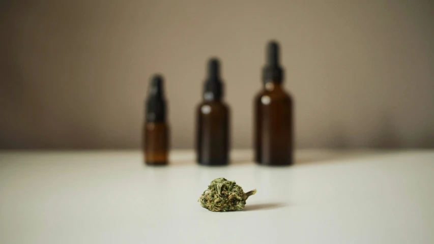 several small brown bottles are sitting on the table