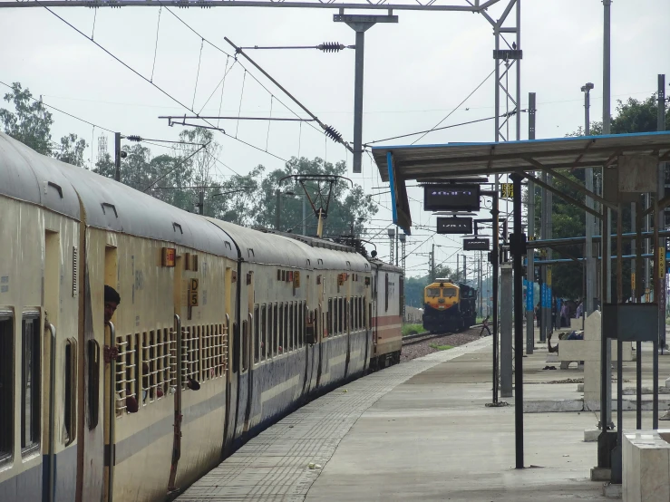 a passenger train sits on the tracks in the station