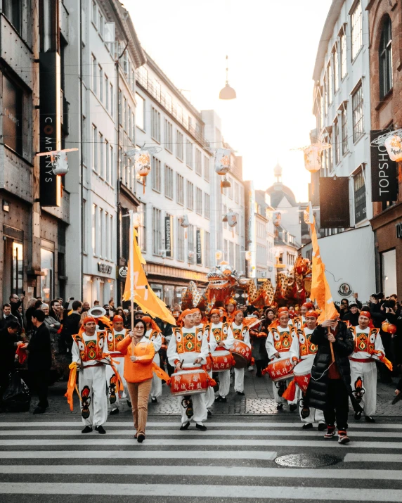 people on a city street wearing marching outfits