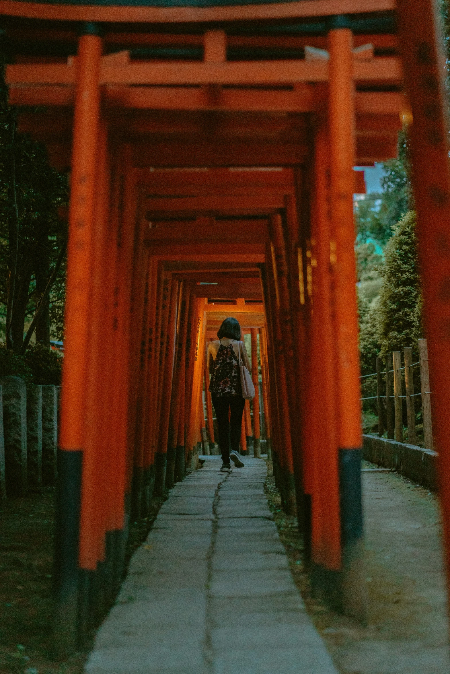 an asian arch in front of two people walking