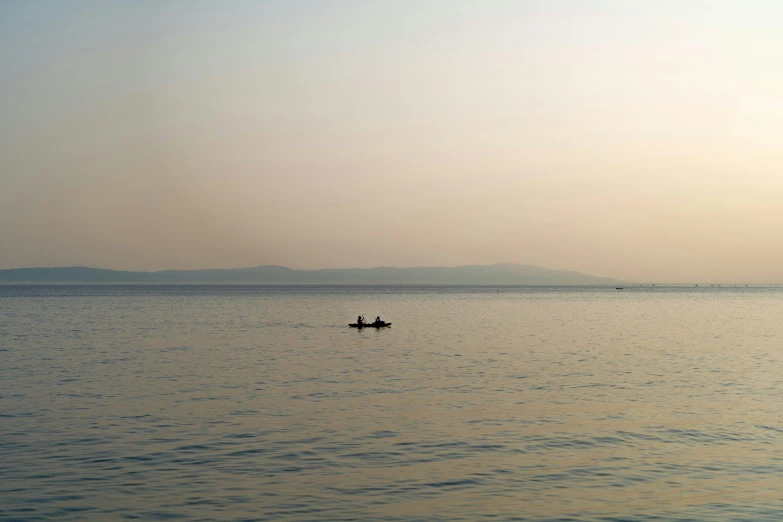 two boats floating in the middle of the ocean