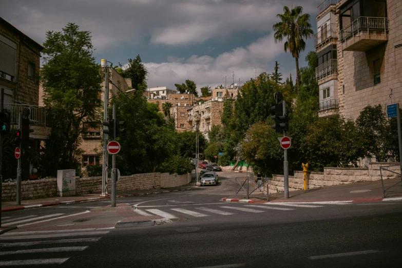 a view of a street from another side, with two people crossing