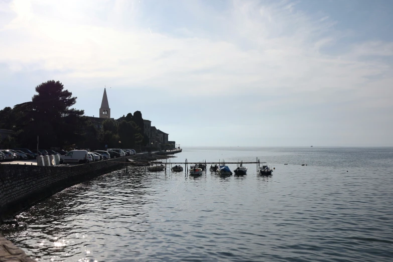 some boats floating in the water by a city