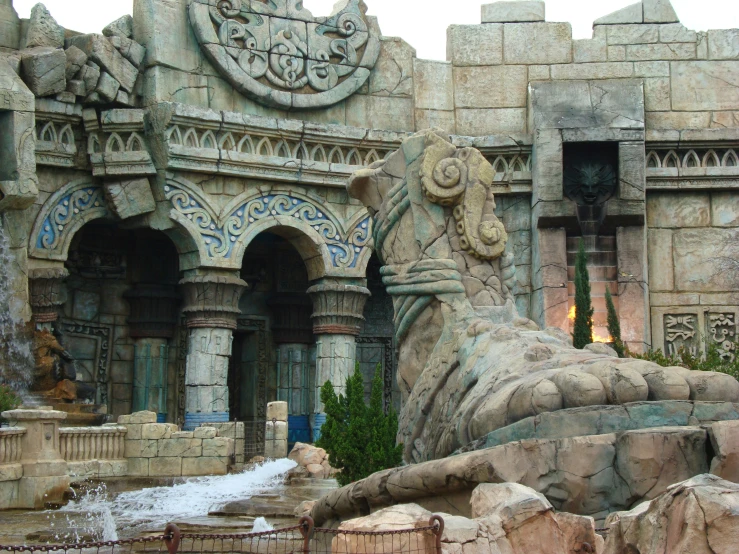 the statue of a horse is placed beside a building