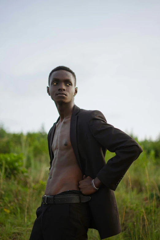 a man in a suit standing in a field