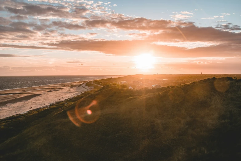 a view over a hill in the middle of the sun