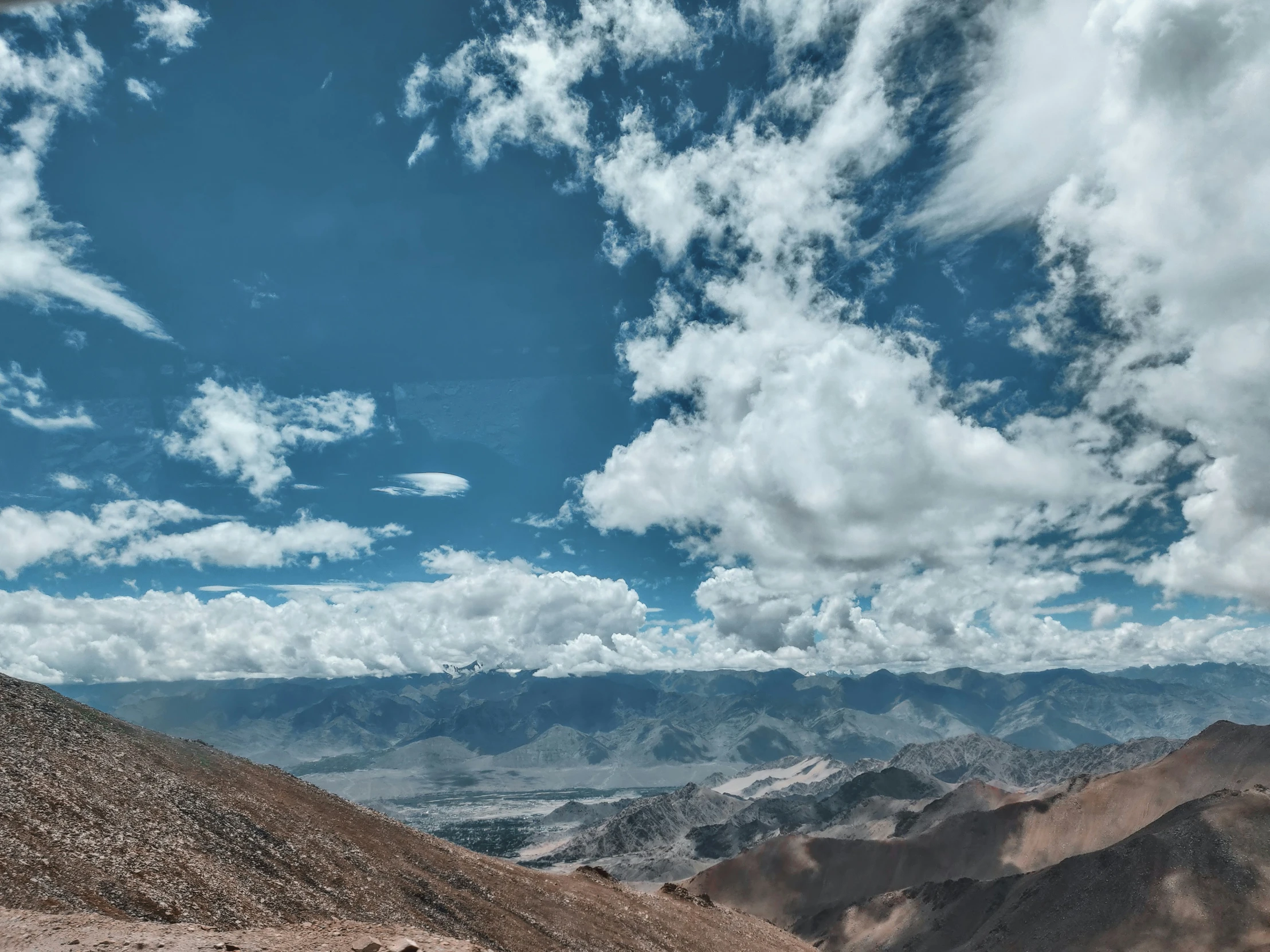 the mountain side with some very cloudy sky