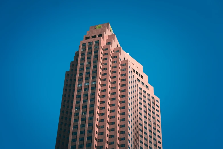 a tall skyscr is seen against the blue sky