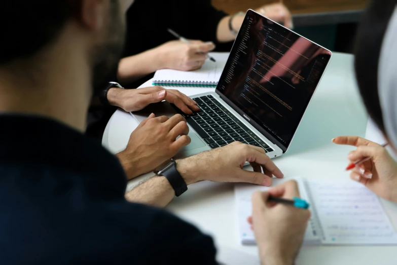 a group of people working on laptop computers