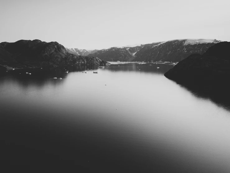 black and white po of water in the middle of a mountain range