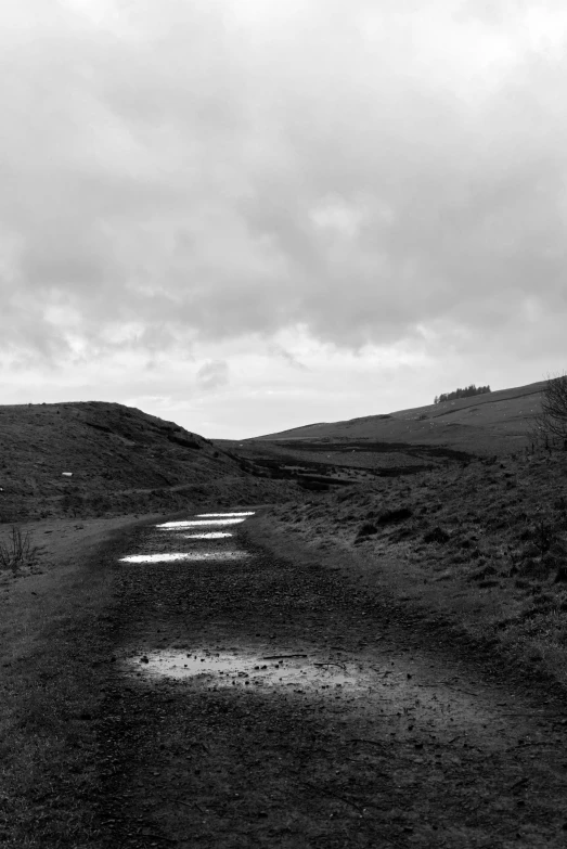 an empty road leading to the top of a hill