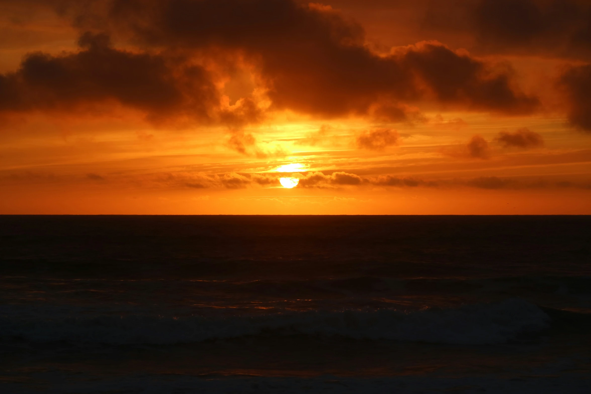 a beautiful sunset in the sky and the water