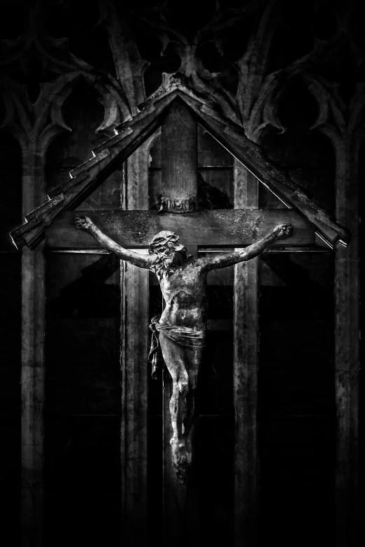 jesus  in a cross in front of a black and white background