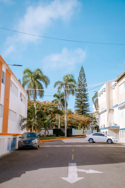 the blue car is parked in front of the building on the corner