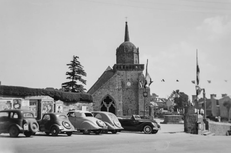 old cars parked in front of an old church