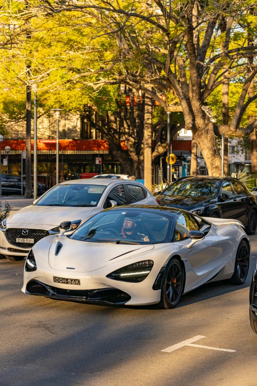 a group of parked cars are stopped in a parking lot