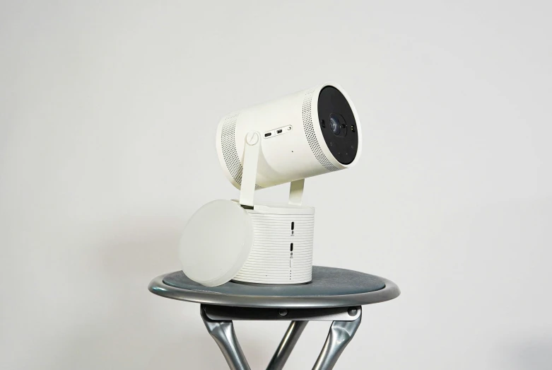 a white video projector sitting on top of a table