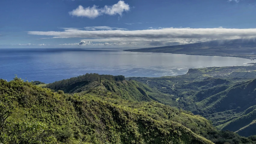 the view over some water with some clouds in the background