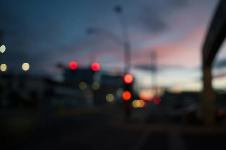 a street filled with lots of traffic at dusk