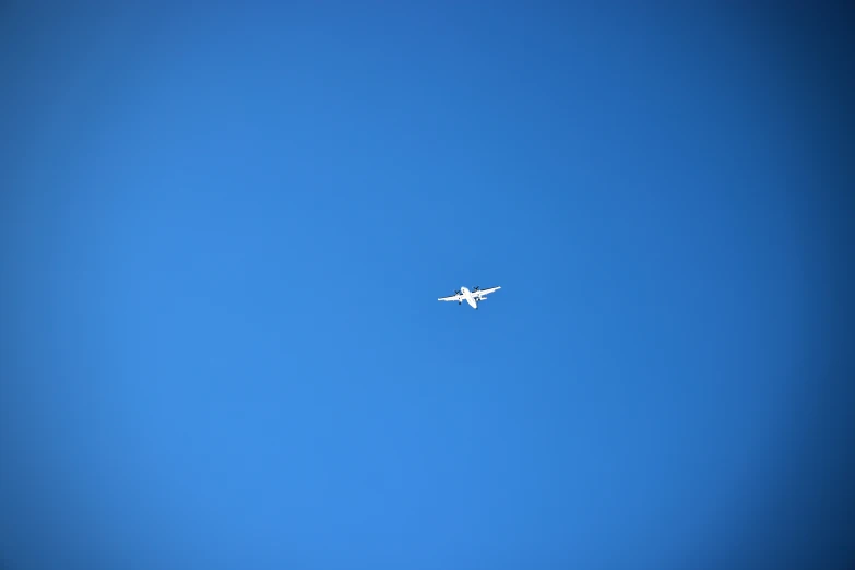 there is a plane flying in the clear blue sky