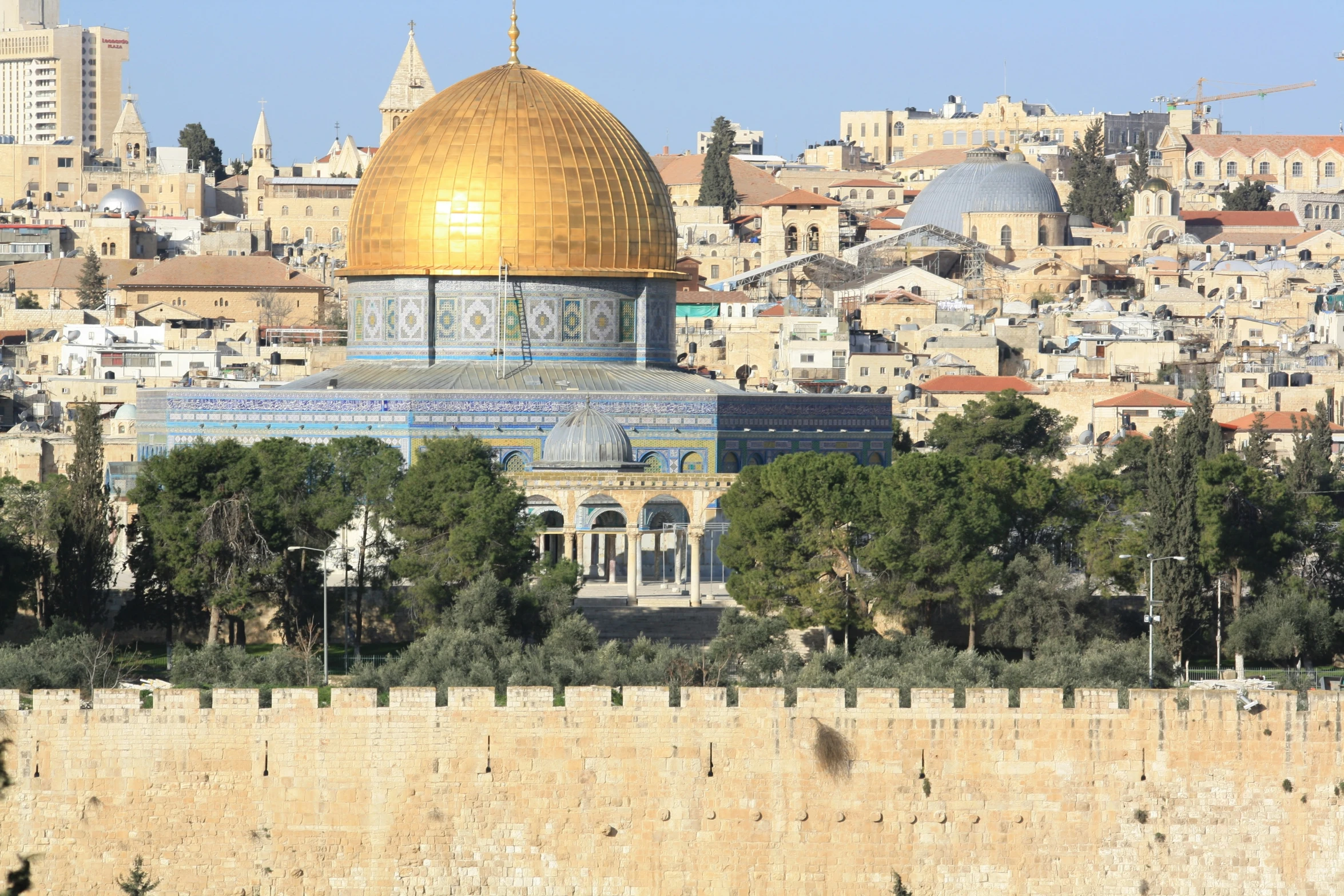 the dome of the rock stands in front of the cityscape