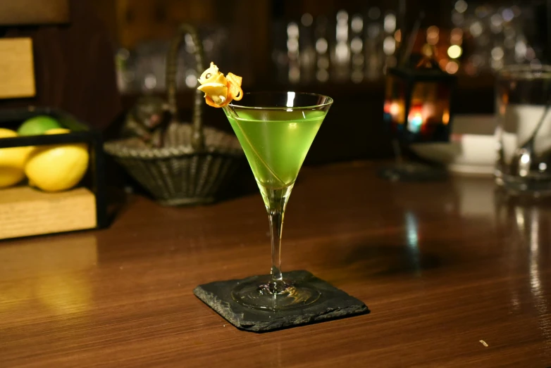 a close up of a green liquid in a glass on a table