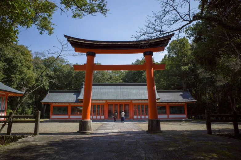 the large orange chinese arch is in front of a building