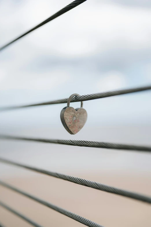 heart shaped padlock on top of barbed wire