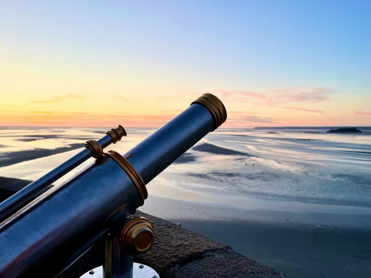 a close up view of a telescope on the beach