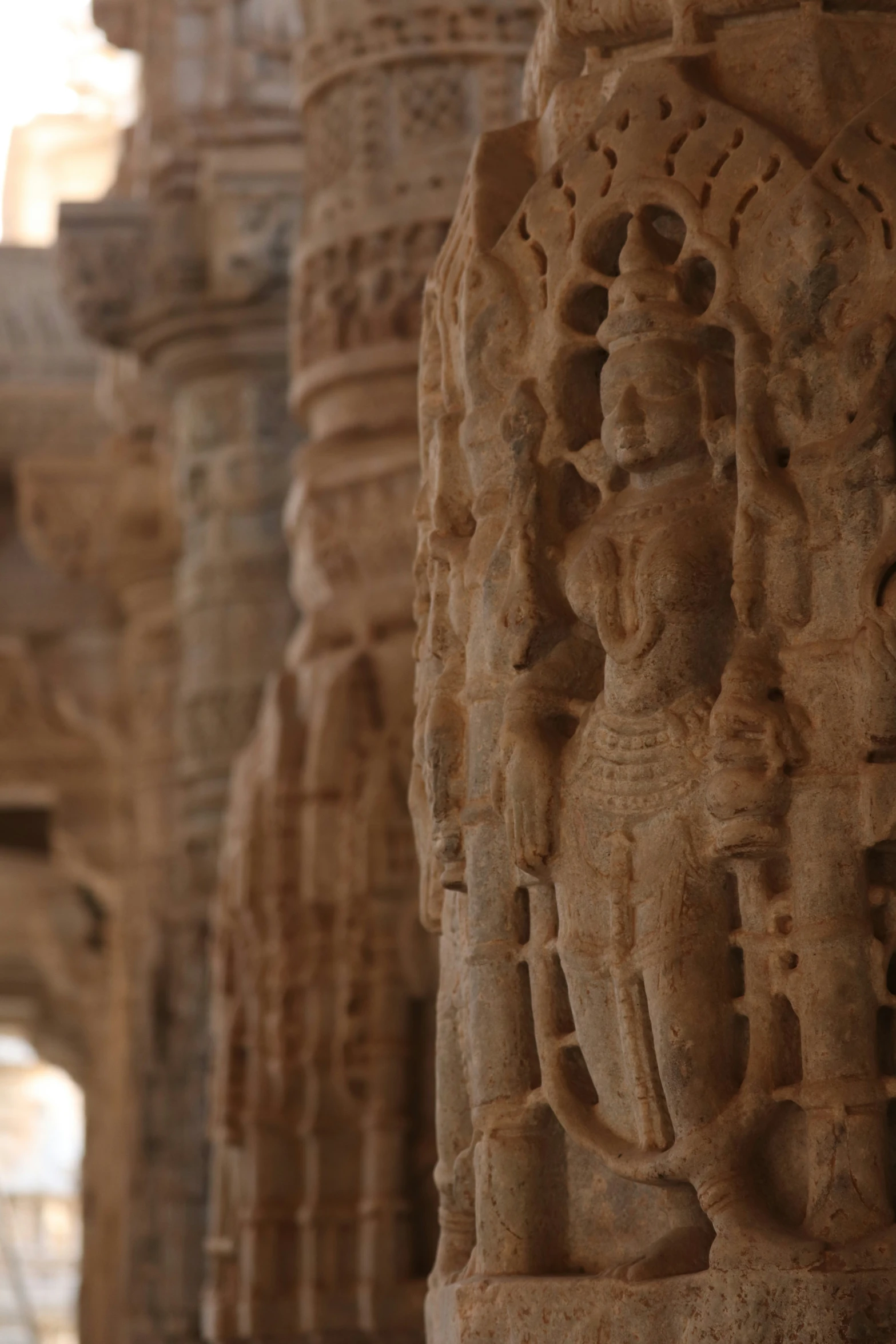 a line of carvings of people in various countries