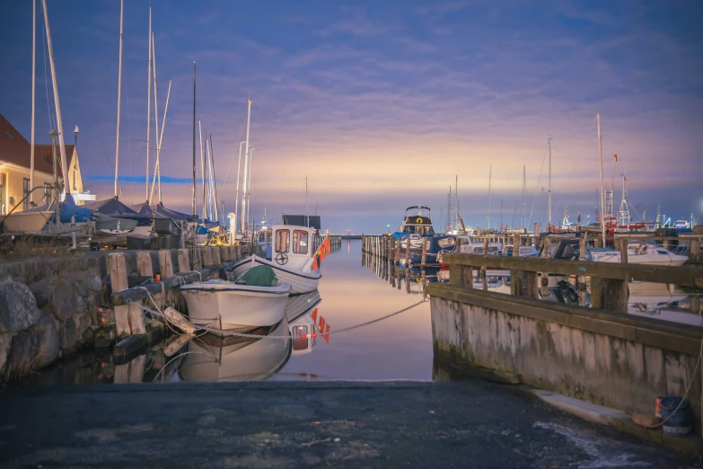 a pier filled with lots of boats on top of water