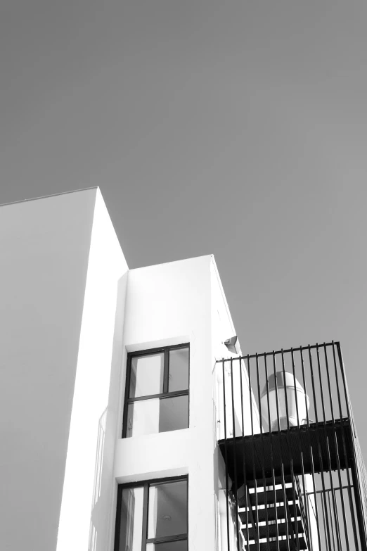 a balcony railing with a white building in the background