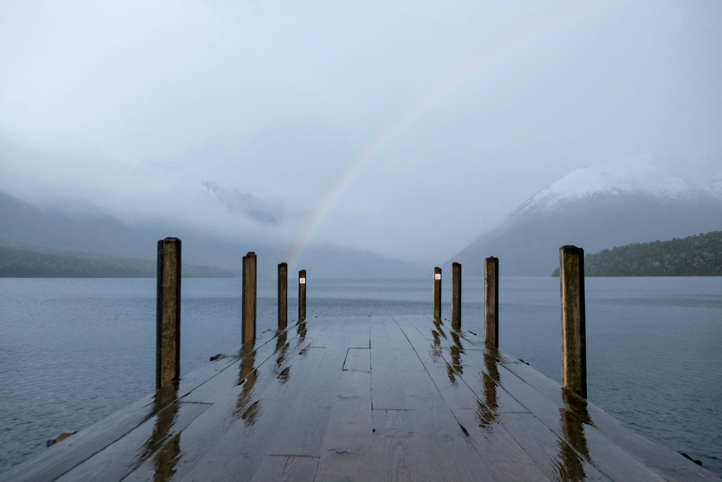 a long pier with some water near by