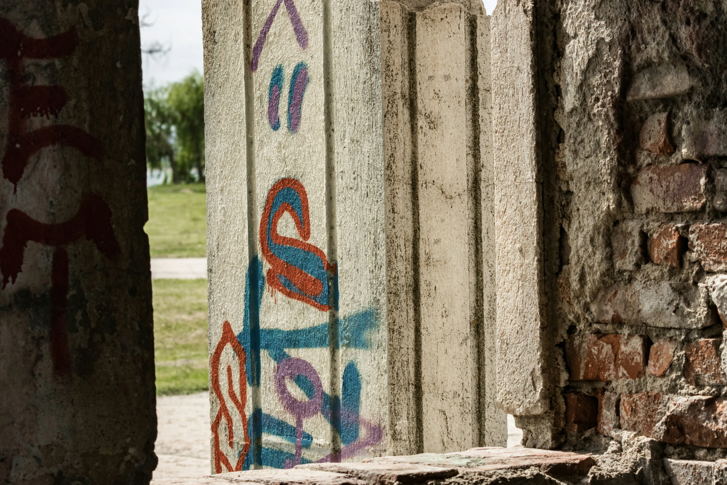 a stone wall with graffiti all over it