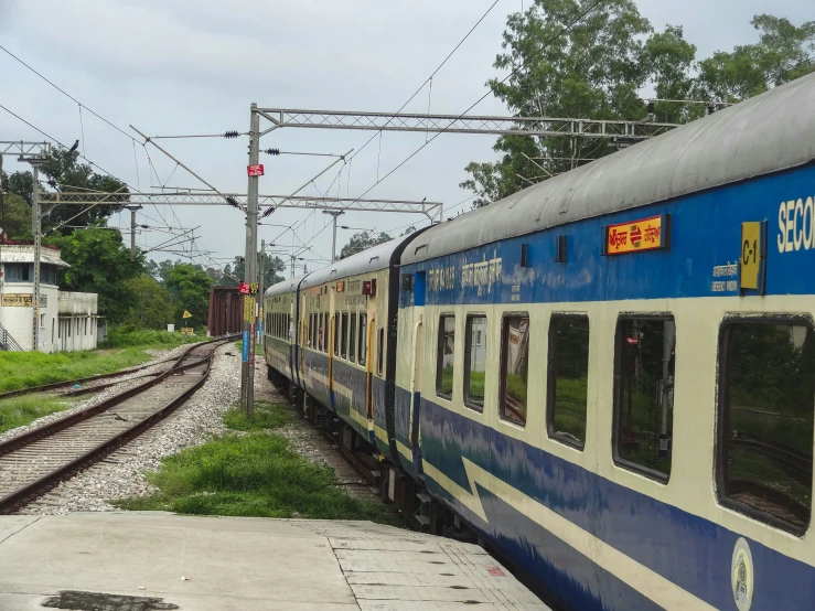 two empty train cars next to a small train station