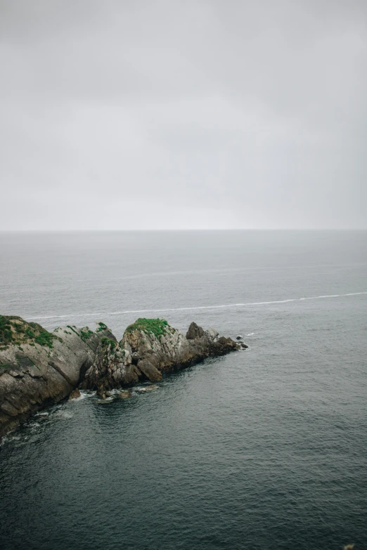 a body of water with a rock out side