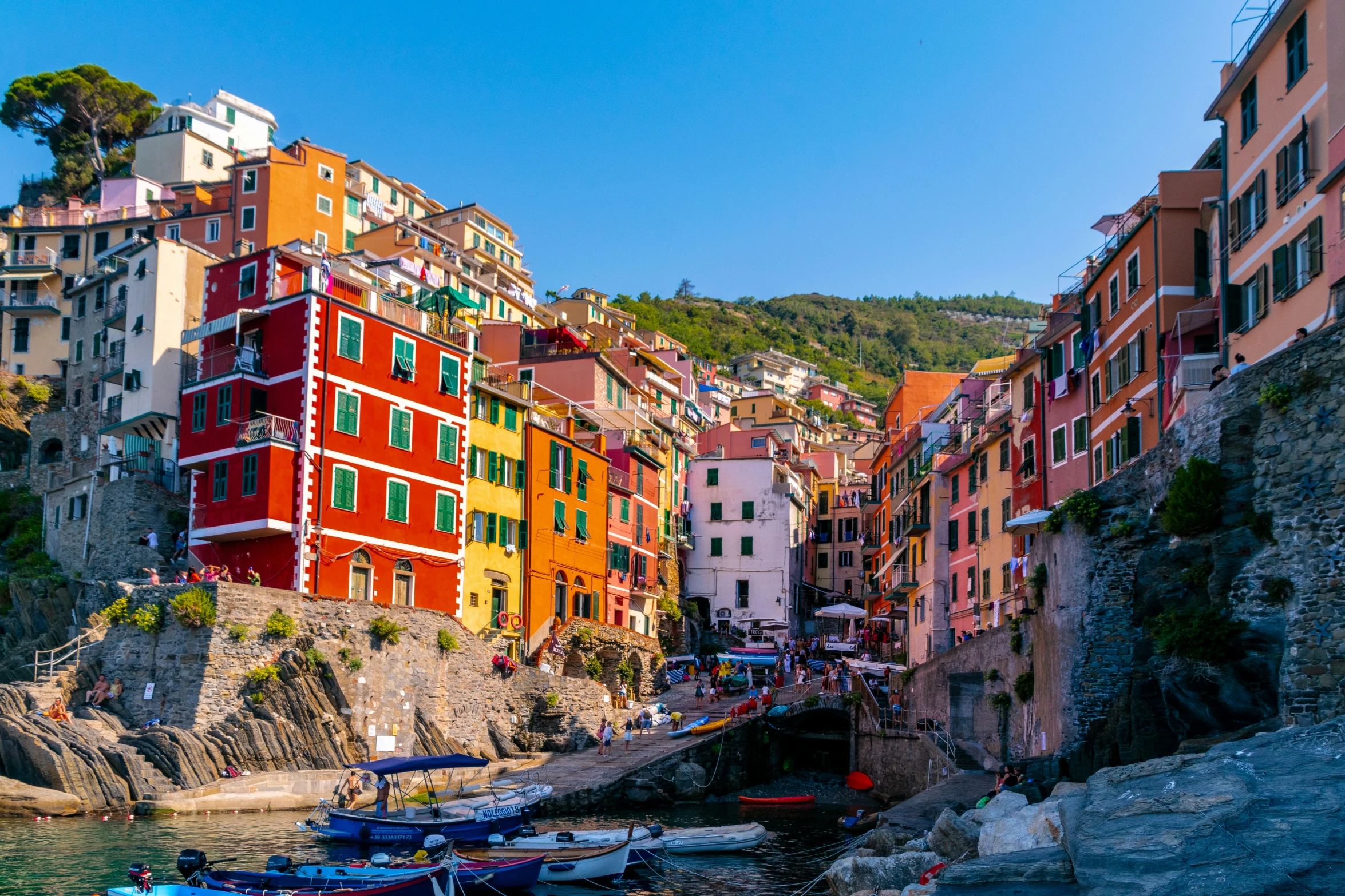 a harbor has boats in it and houses on the cliffs