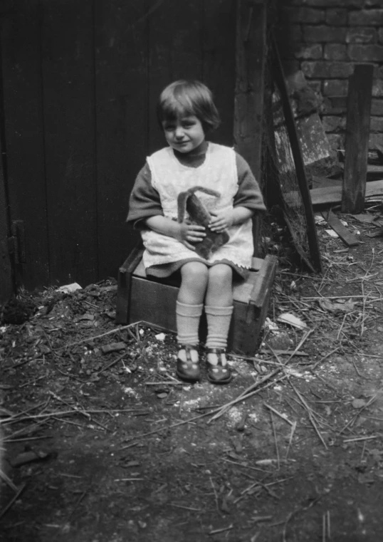 an old pograph of a young child holding a bird