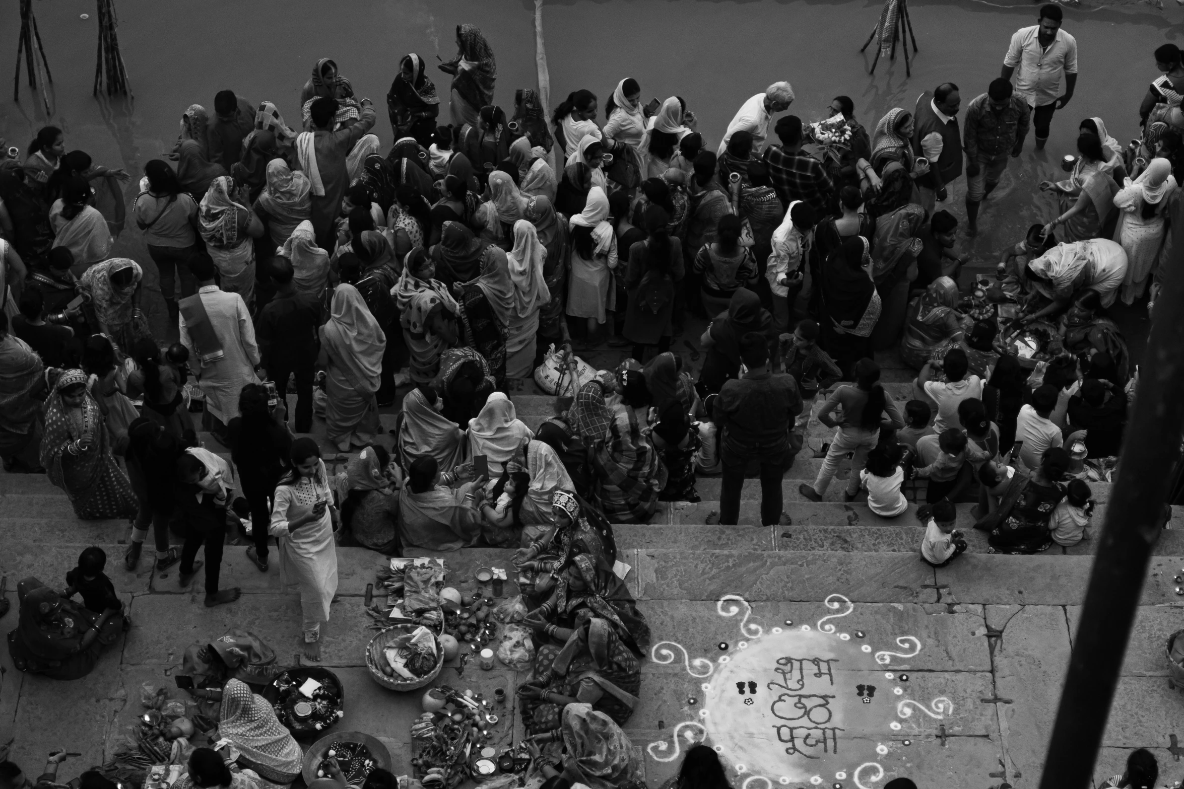 a crowd of people sitting around tables outdoors