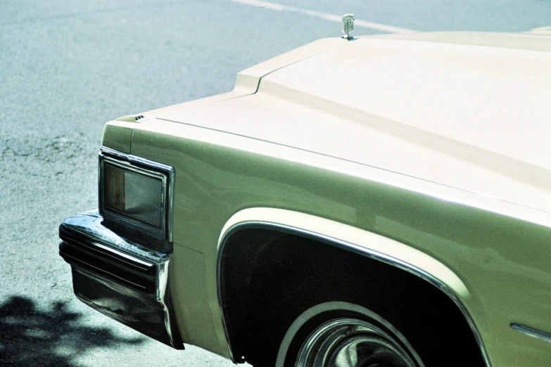 an old, light green chevrolet coupe with its door opened