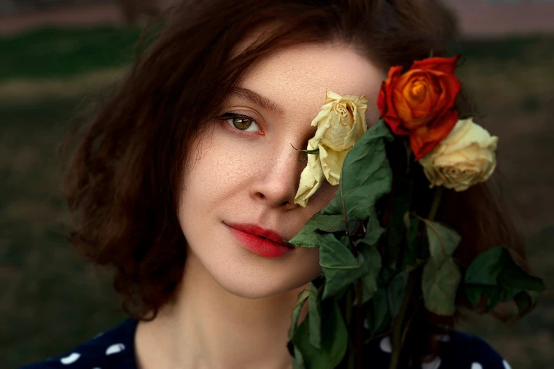 a woman holding flowers and looking in the same direction