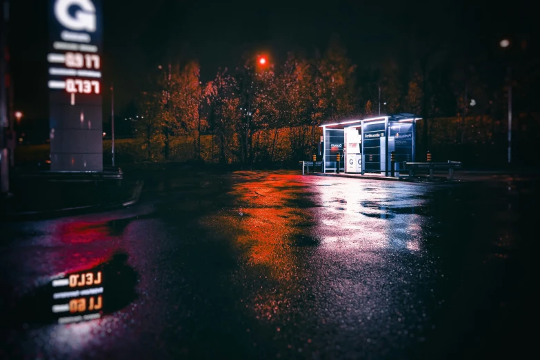 a wet, rainy night with trees behind some toilet trailers