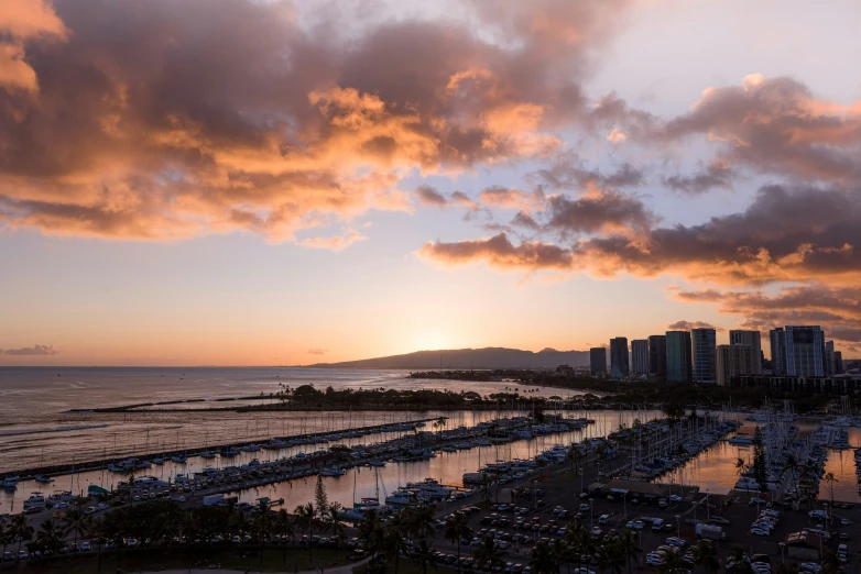 sunset over the marina in a city next to the ocean