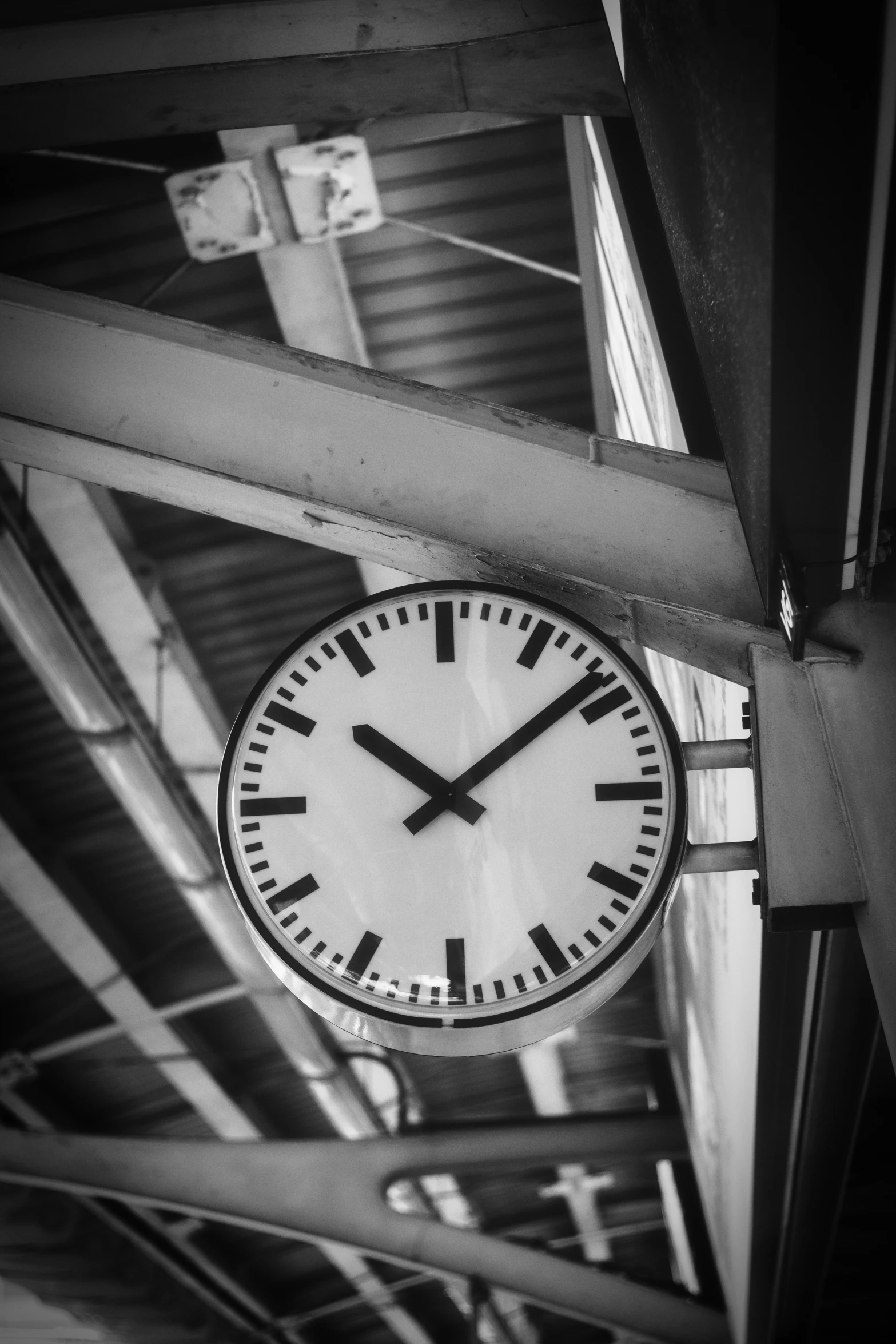 black and white po of a clock inside of a building